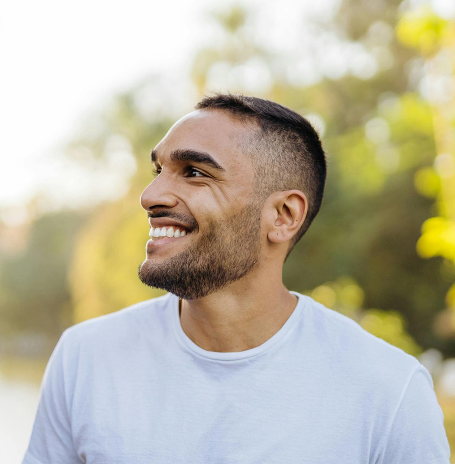 Man smiling with his head turned to the side