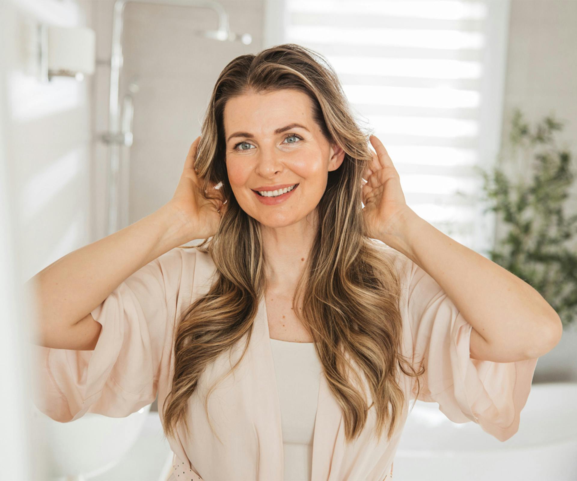 Woman smiling fixing hair