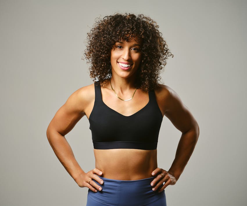 Woman smiling with hands on hips