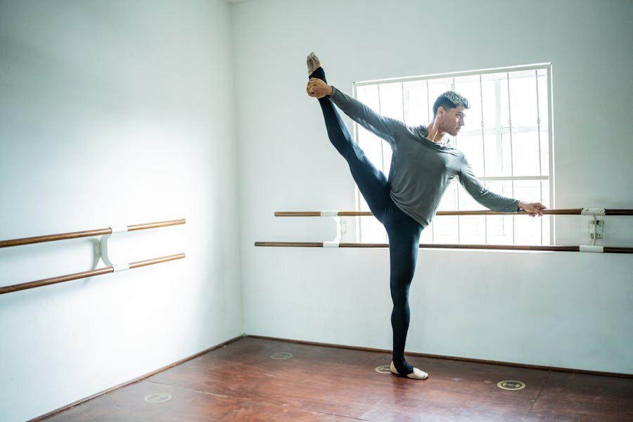 Male dancer doing the standing splits healing from hip pain