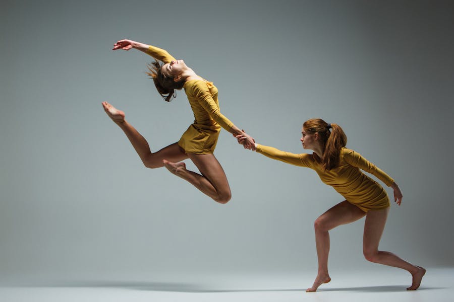 Dancers doing a beautiful jump showing off flexibility and ankle mobility