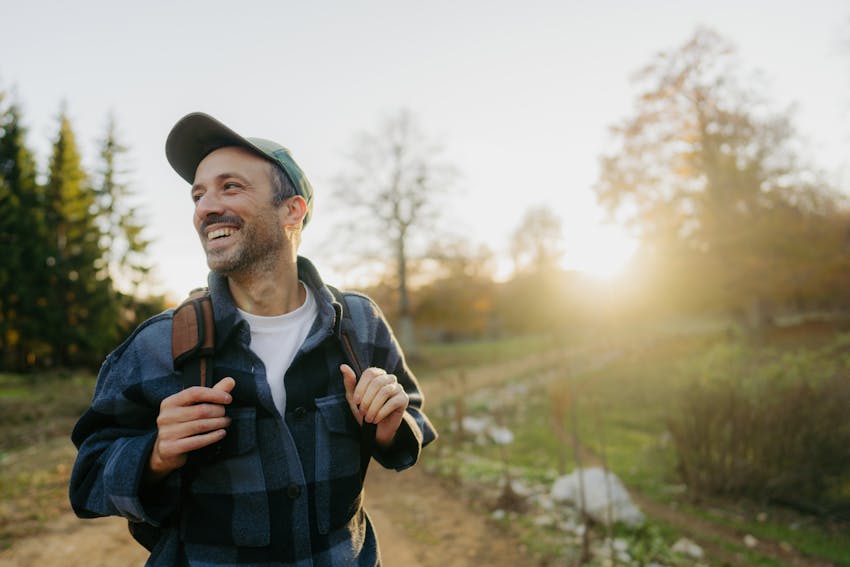 Man wearing a backpack walking outside