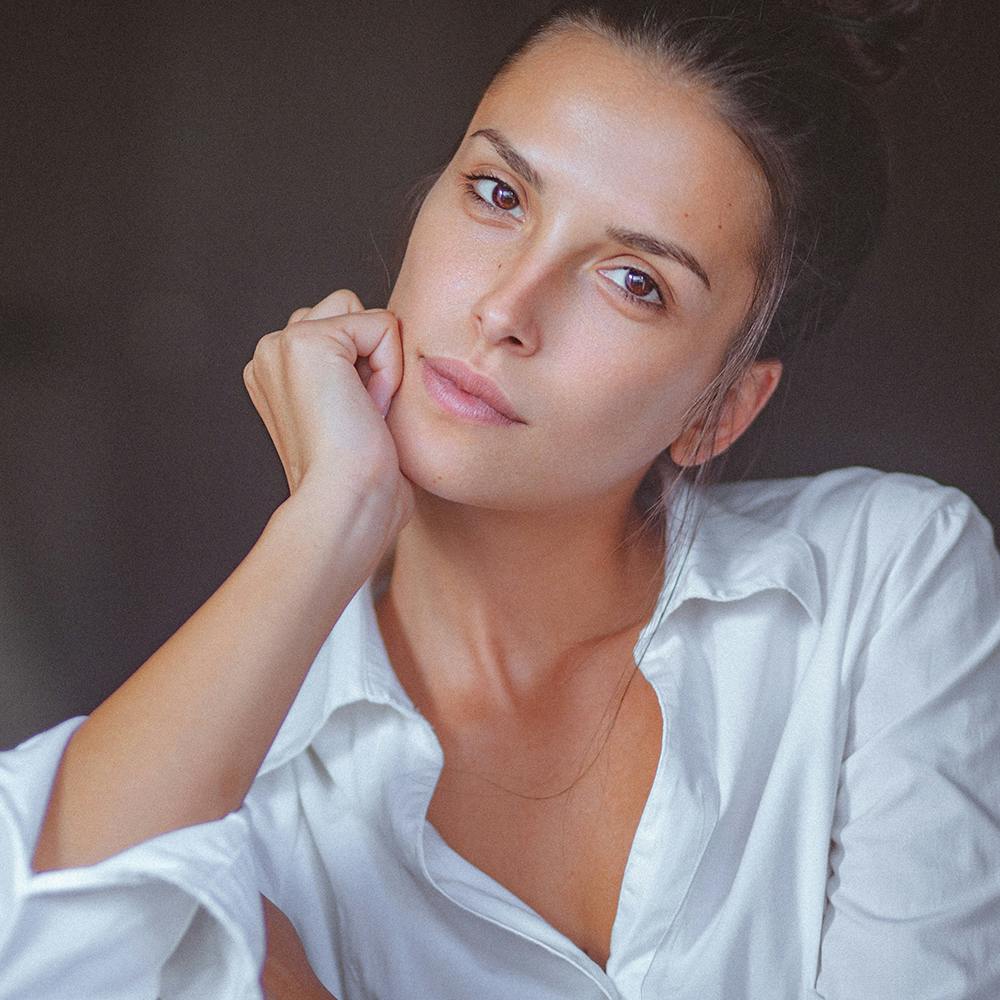 woman with her hand on her face