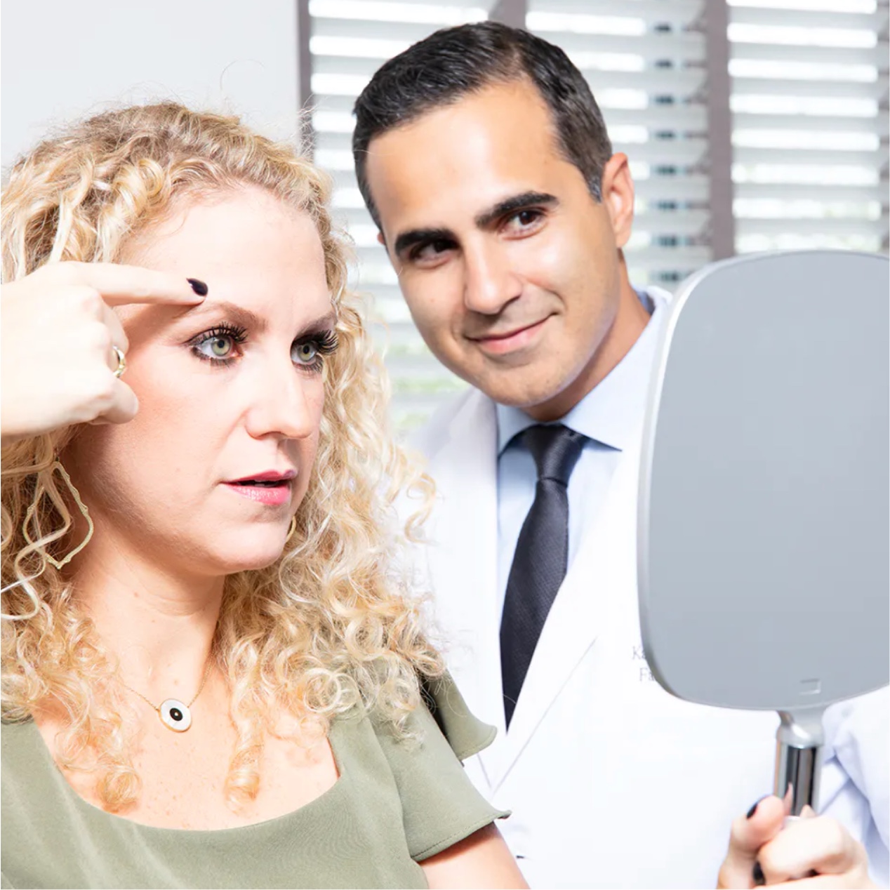 Dr. Saigal assisting a female patient