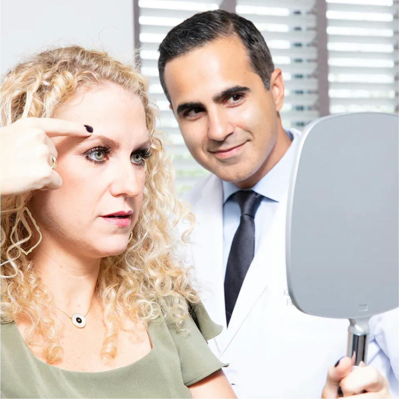 Dr. Saigal assisting a female patient