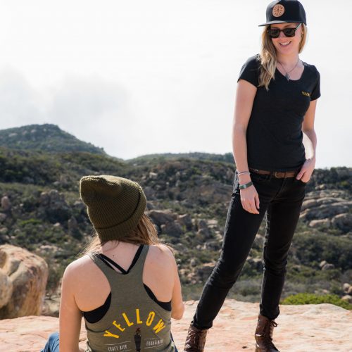 Image of a girl wearing the Yellow Belly tank top and another girl wearing a Yellow Belly tee shirt