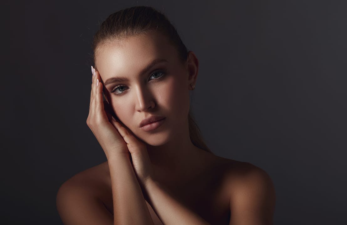 woman with her hands on the side of her face