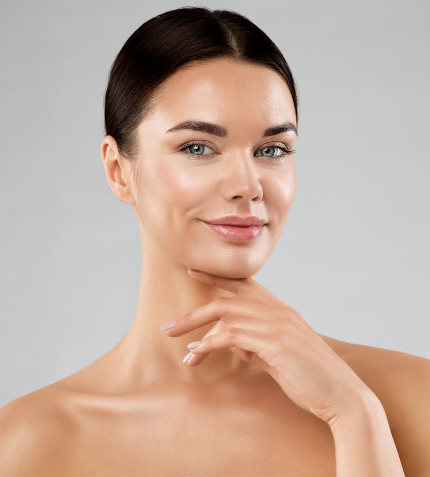 Woman touching chin and smiling