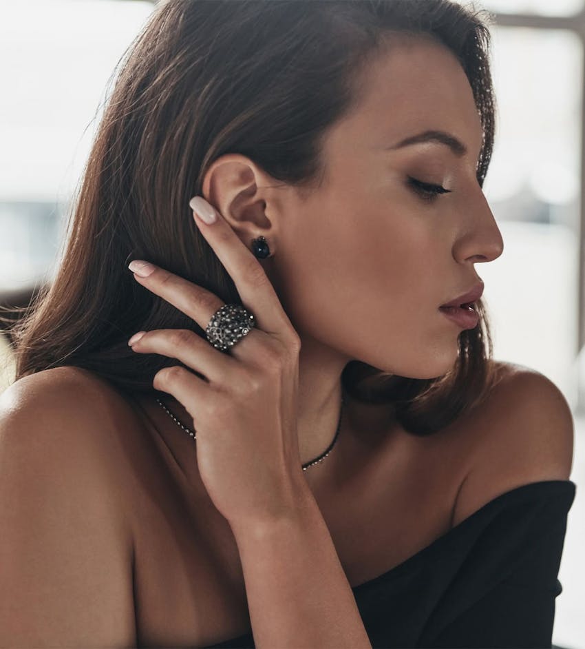 Woman brushing hair behind ear