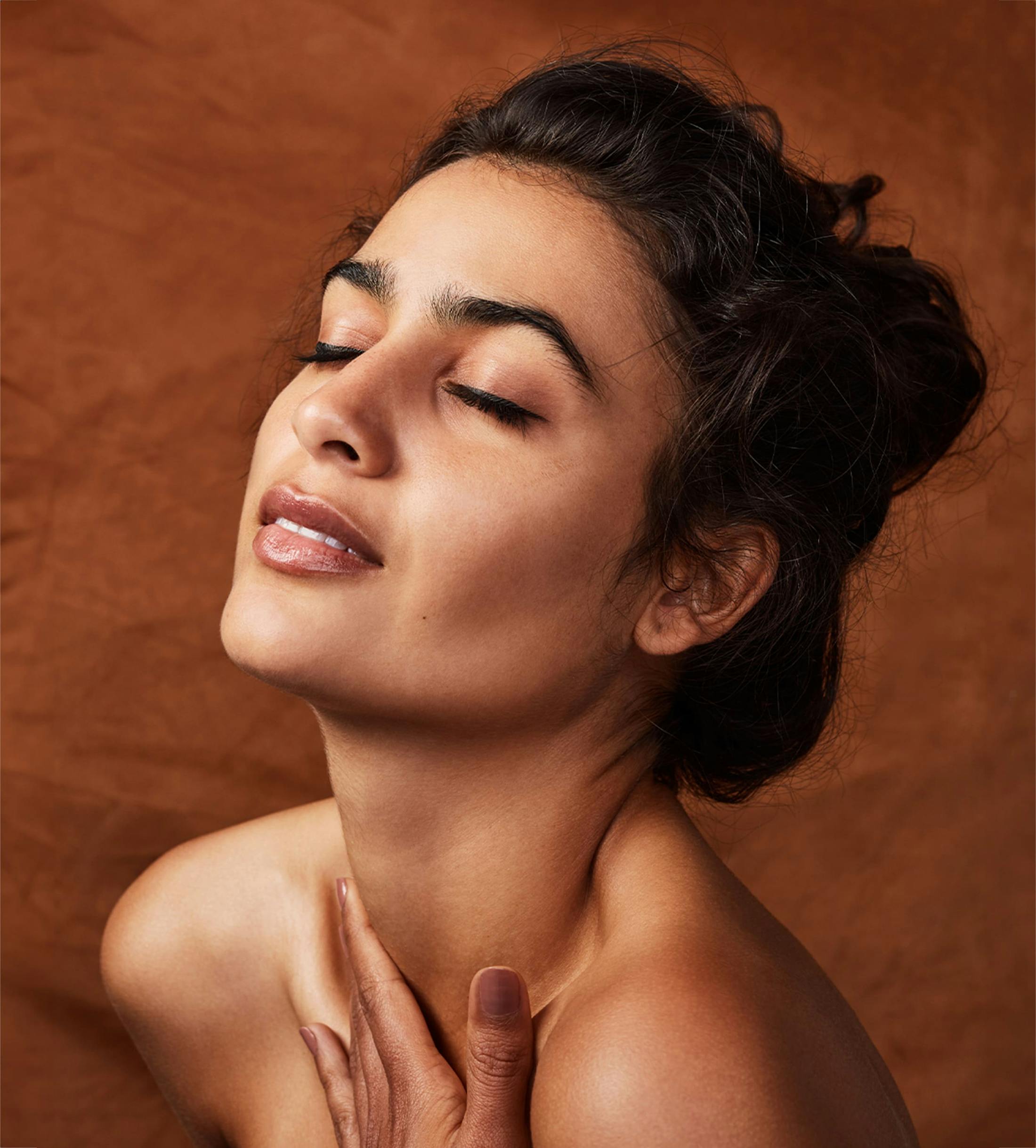 Woman with eyes closed touching chest