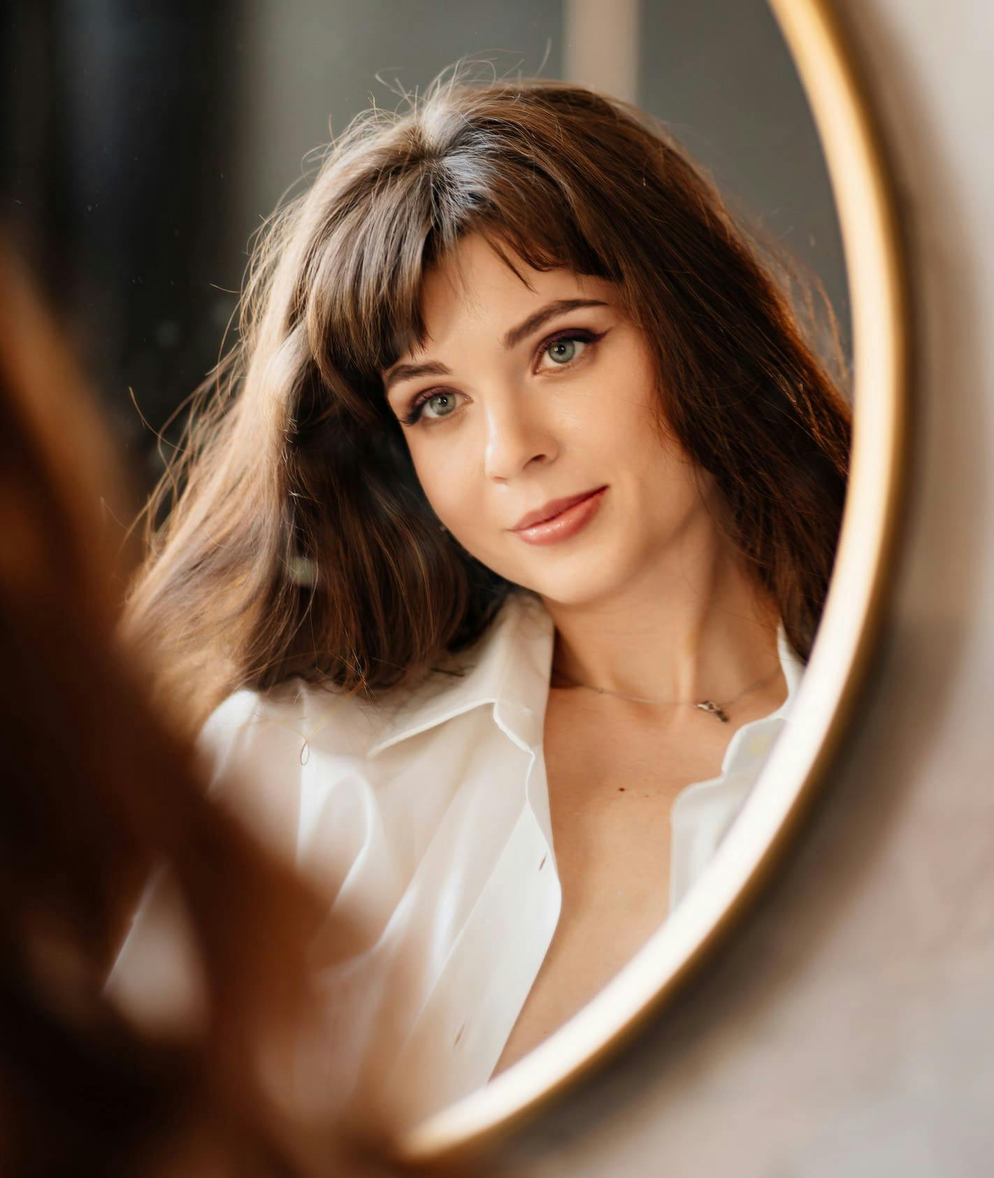 woman looking at herself in a mirror