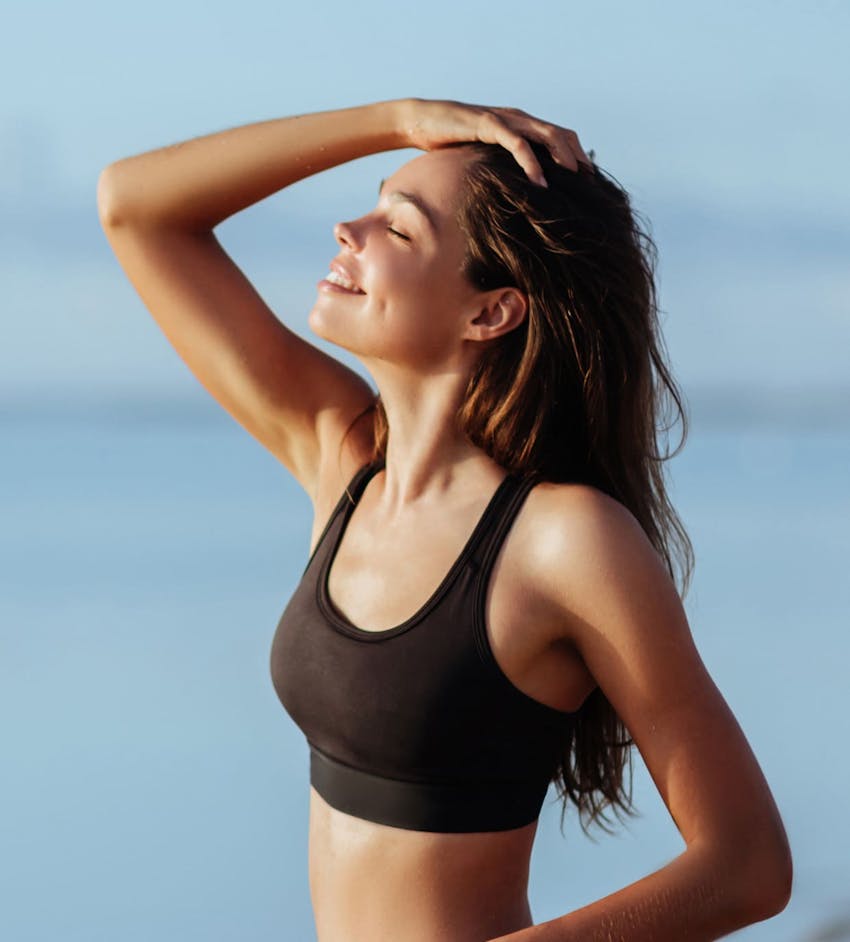 Woman outside with hand in hair