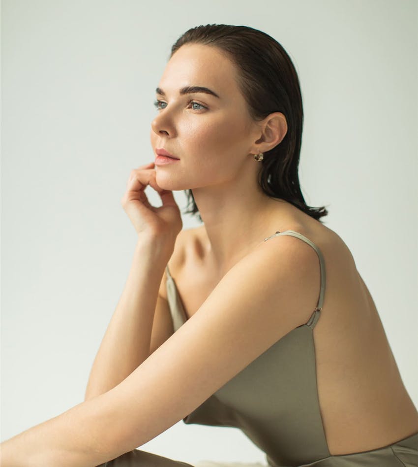 Woman sitting and touching chin