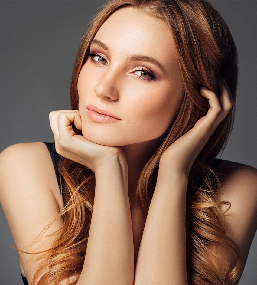 Woman resting chin on hand