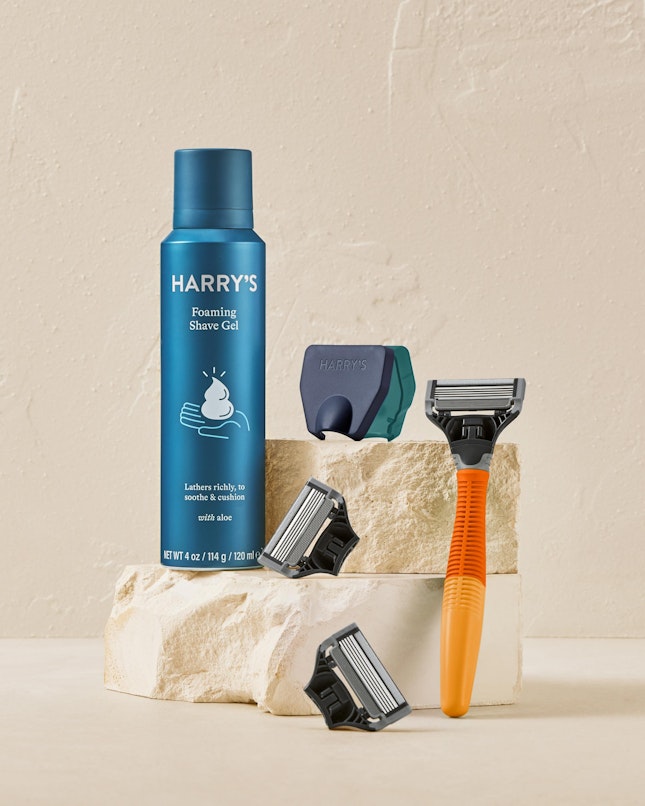 Harry's orange truman handle, shave gel, travel blade cover and razor blades