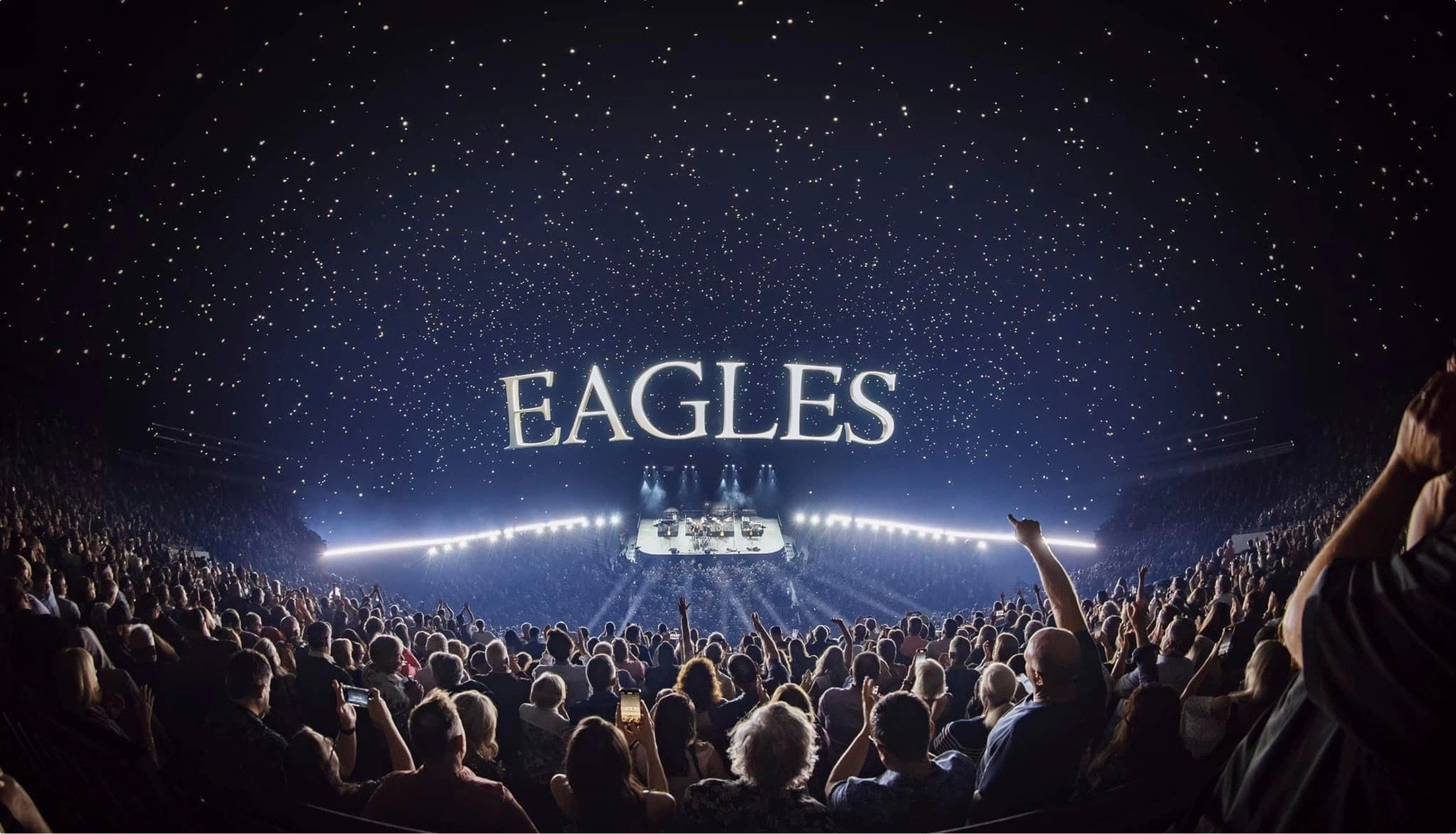Wide angle lens of the audience and Eagles logo in starry sky video content at Sphere Las Vegas