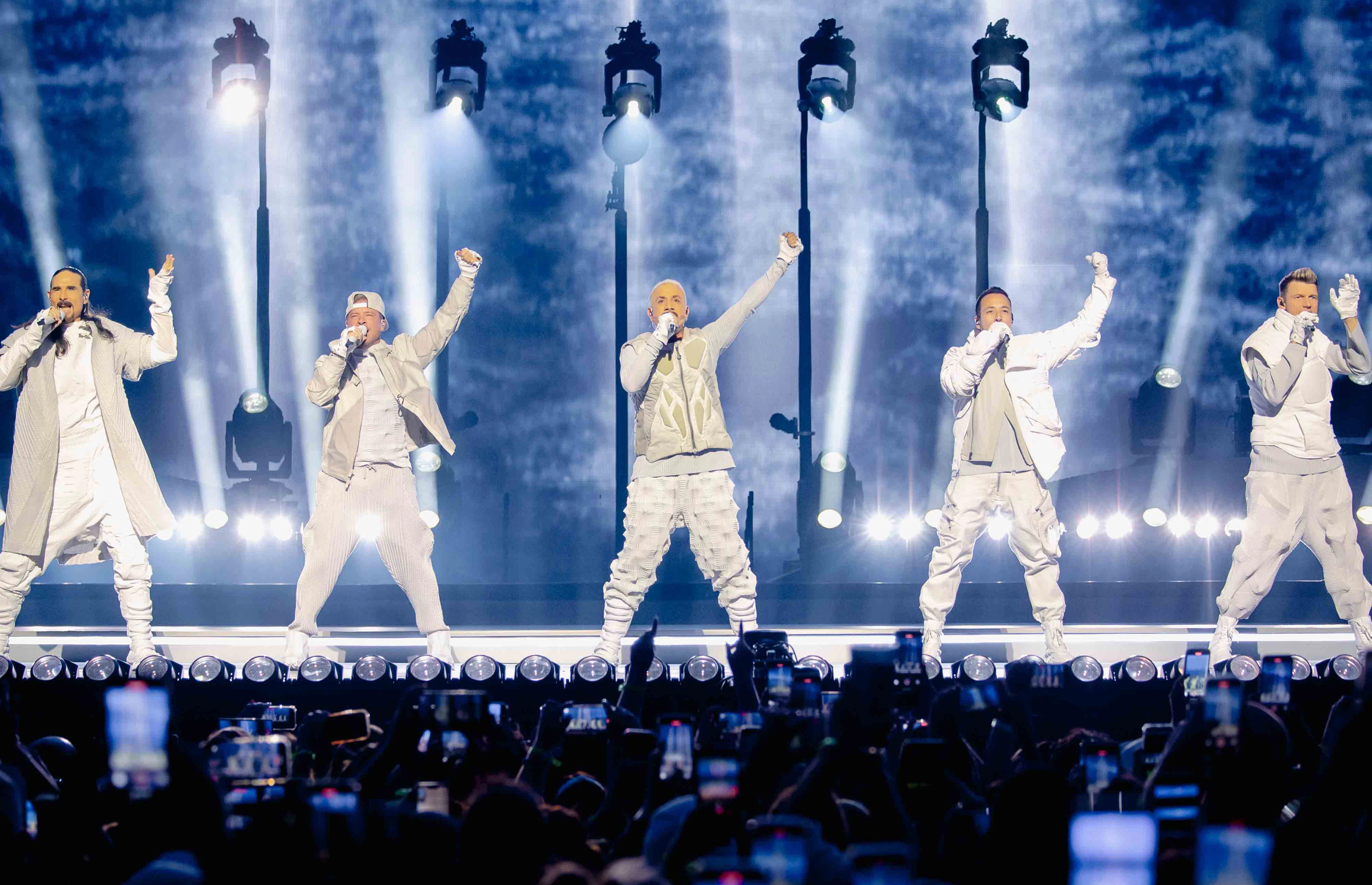 Backstreet Boys - Sphere Las Vegas Intro The Millenium - Silent House Backstreet Boys on Sphere stage with arms raised under blue and white lighting, audience phones visible in foreground.