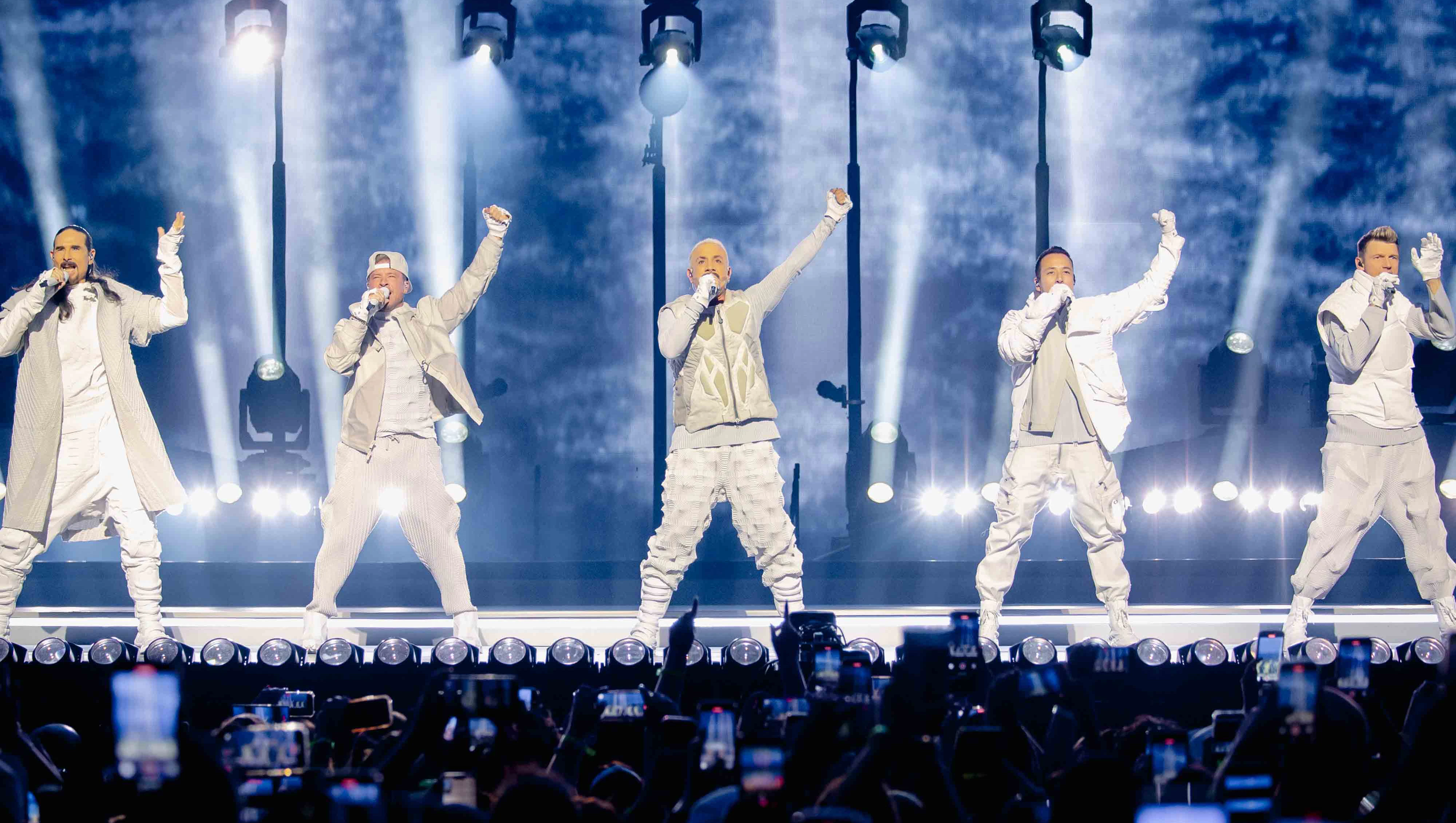 Backstreet Boys - Sphere Las Vegas Intro The Millenium - Silent House Backstreet Boys on Sphere stage with arms raised under blue and white lighting, audience phones visible in foreground.