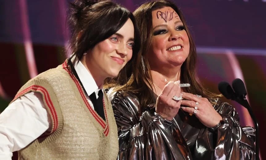 Billie Eilish and Melissa McCarthy - 30th Screen Actors Guild Awards - Silent House Billie Eilish and Melissa McCarthy present an award at the 30th Screen Actors Guild Awards. Billie Eilish autographs Melissa McCarthy's forehead with a marker.