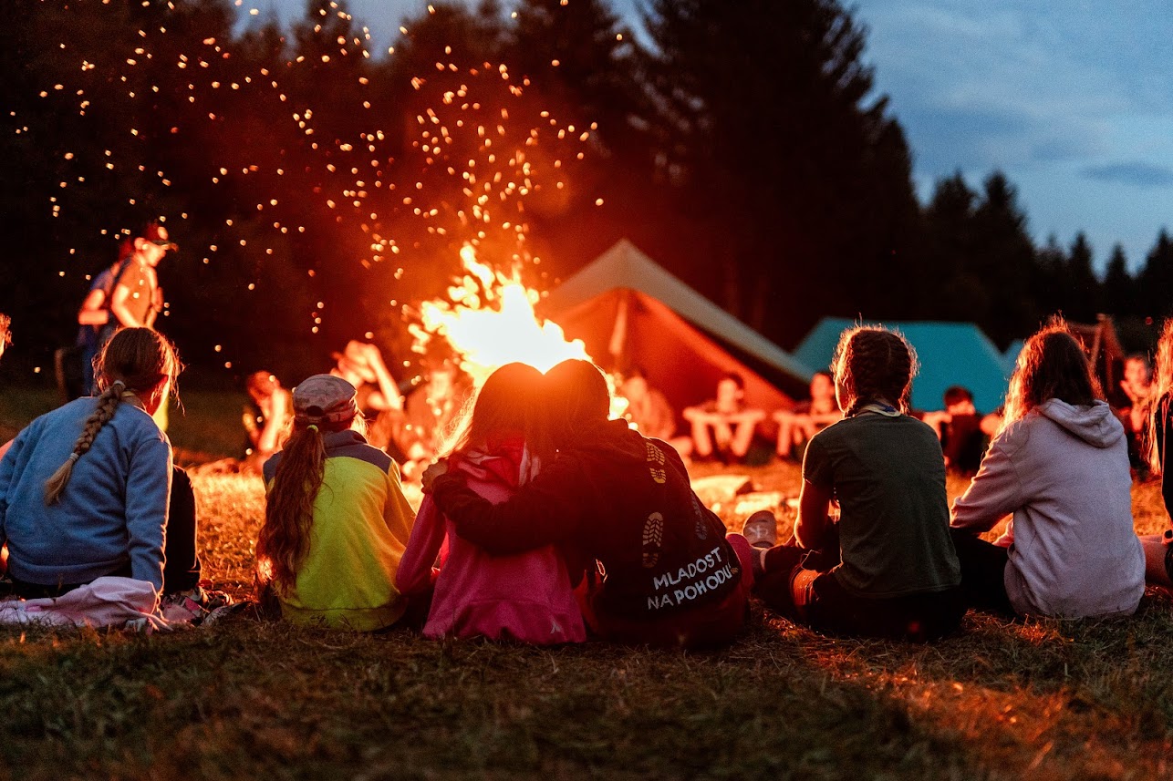 Scouts and guides around campfire