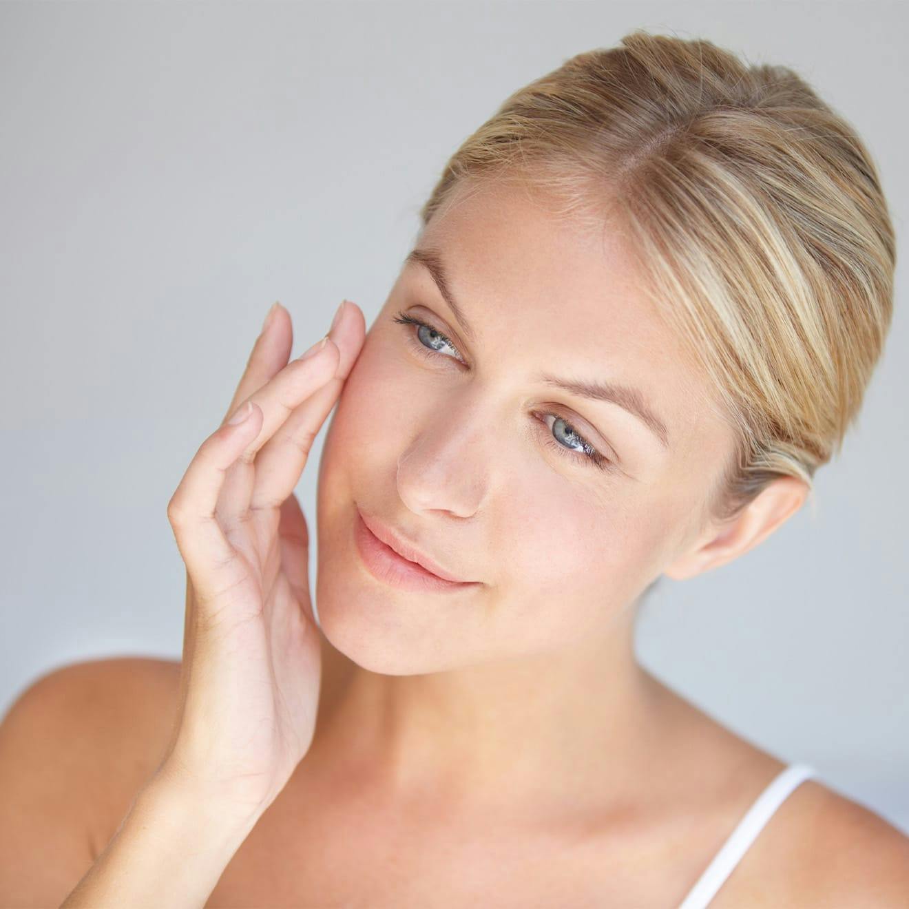 woman touching her face