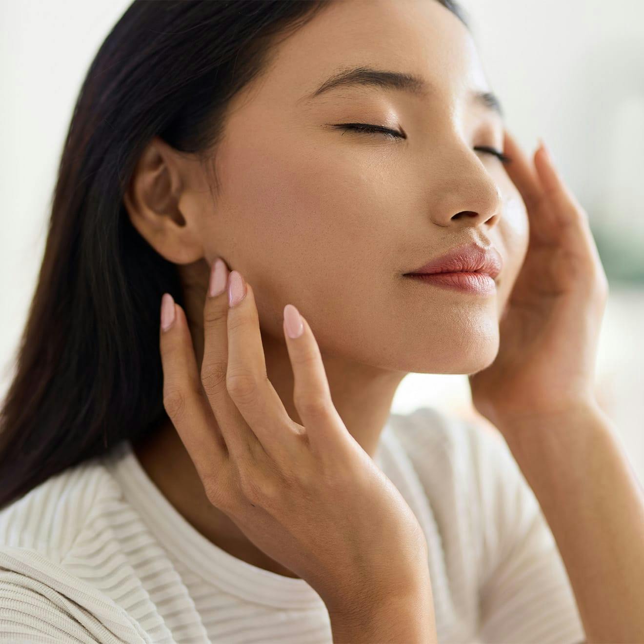 woman touching her face