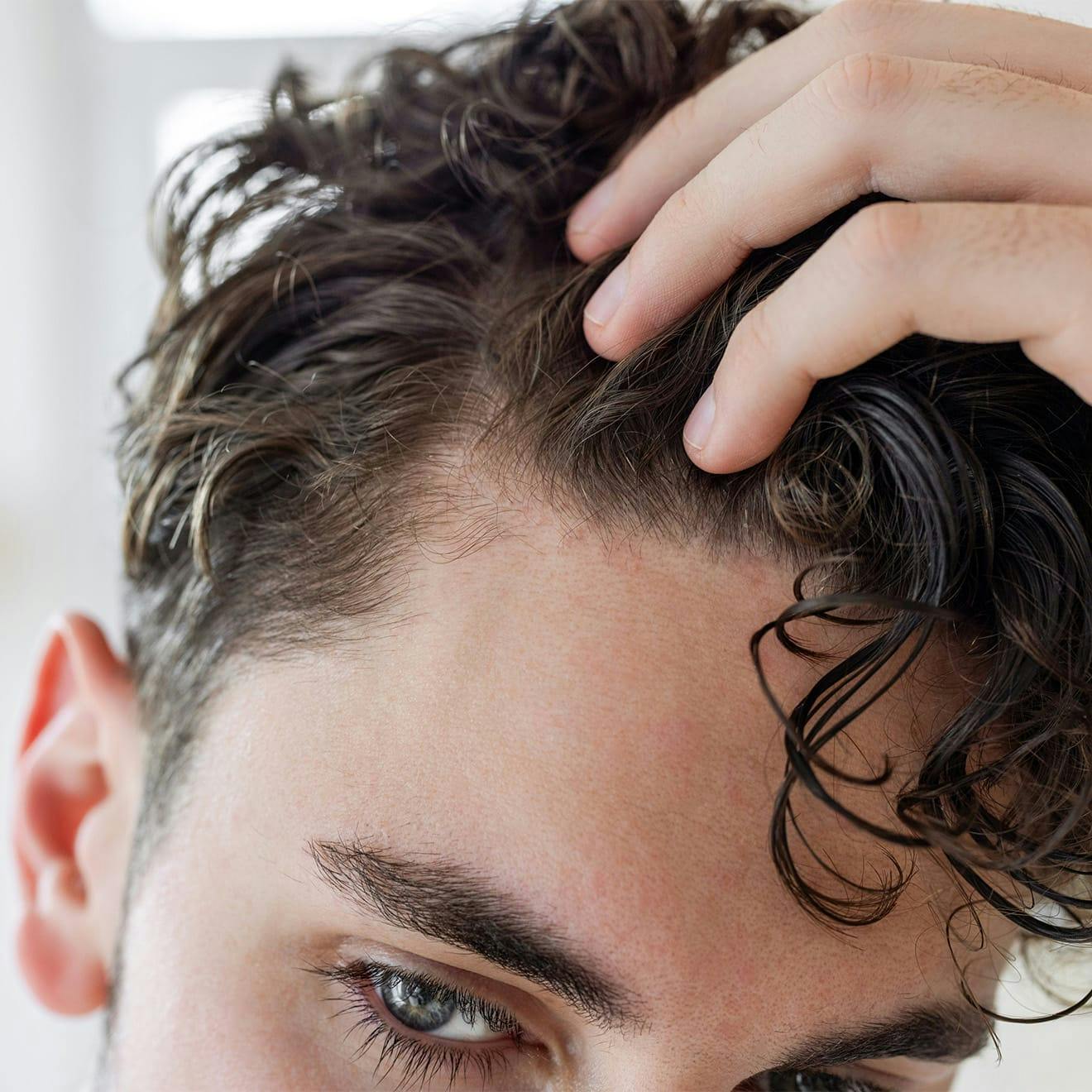 Man pulling hair back