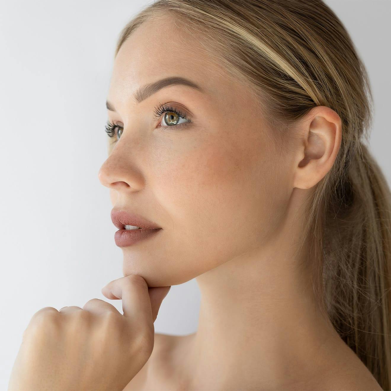 woman touching her chin