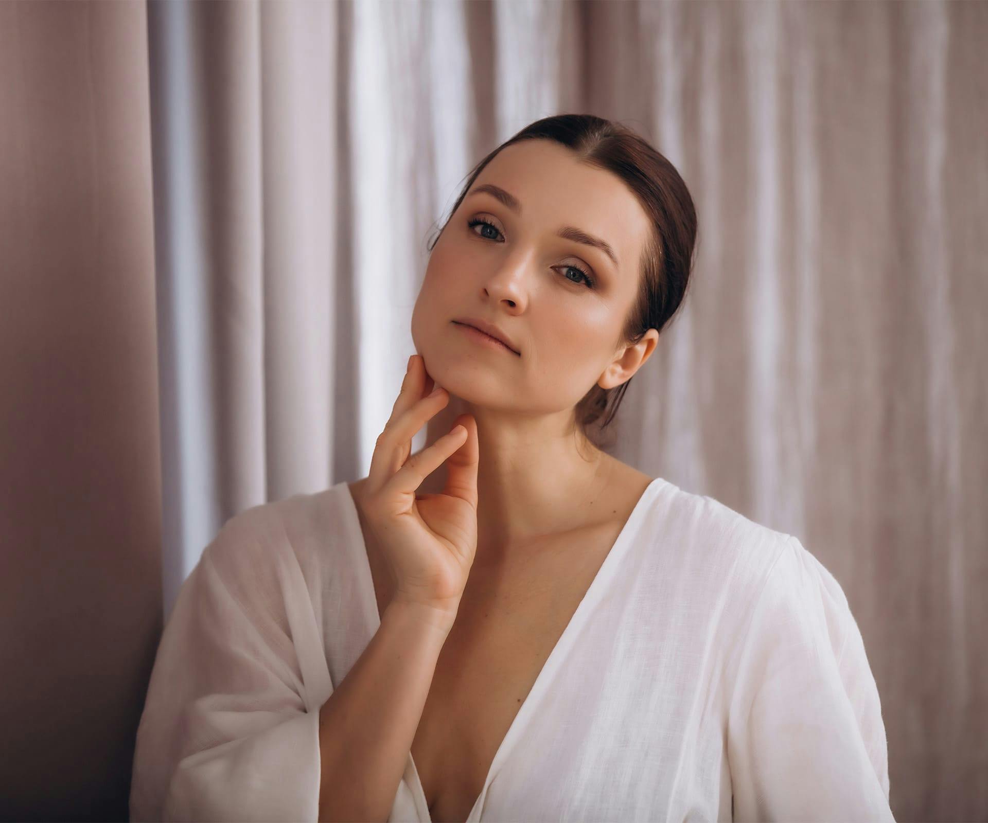 woman touching her face