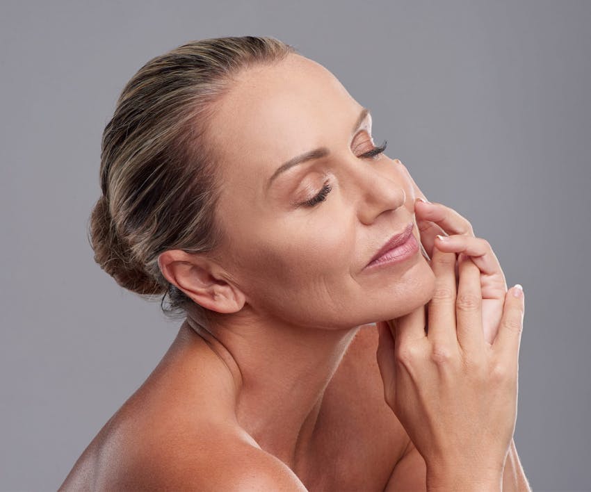 woman touching her face