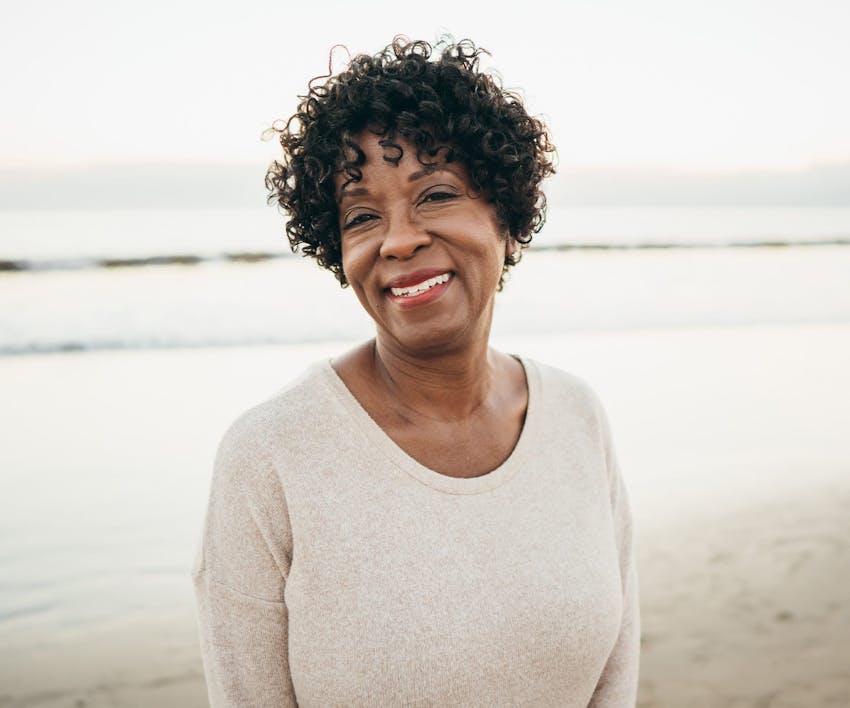 woman with curly hair smiling