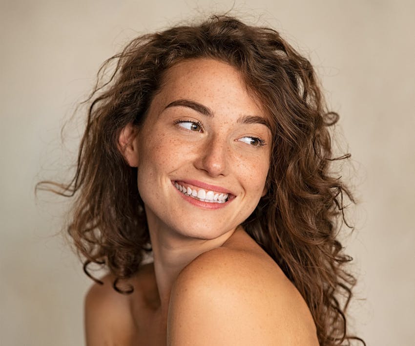 Woman looking over shoulder smiling