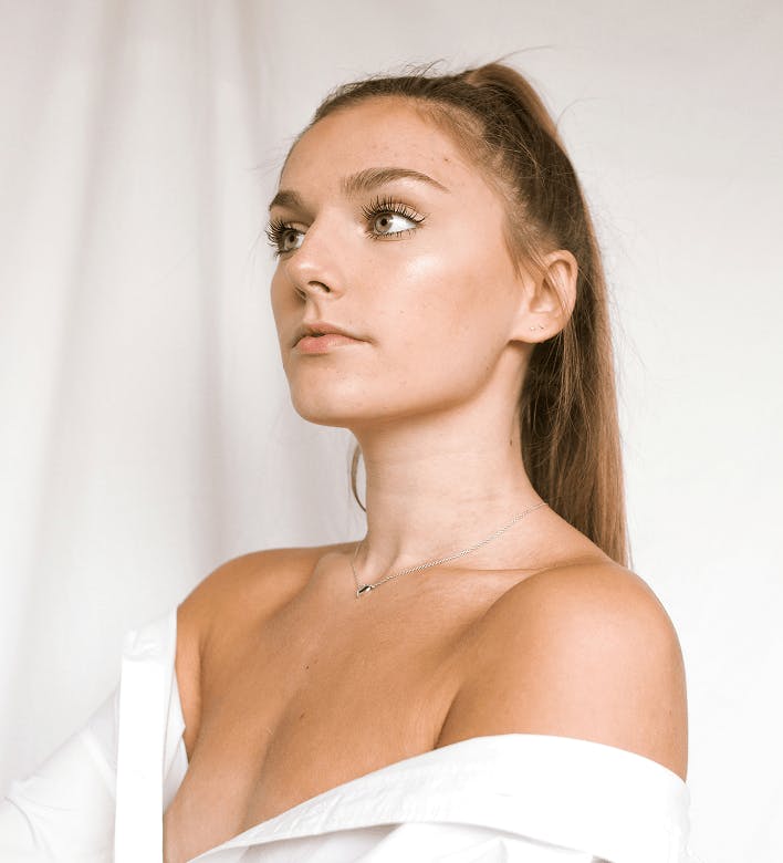 woman with her shirt off her shoulders