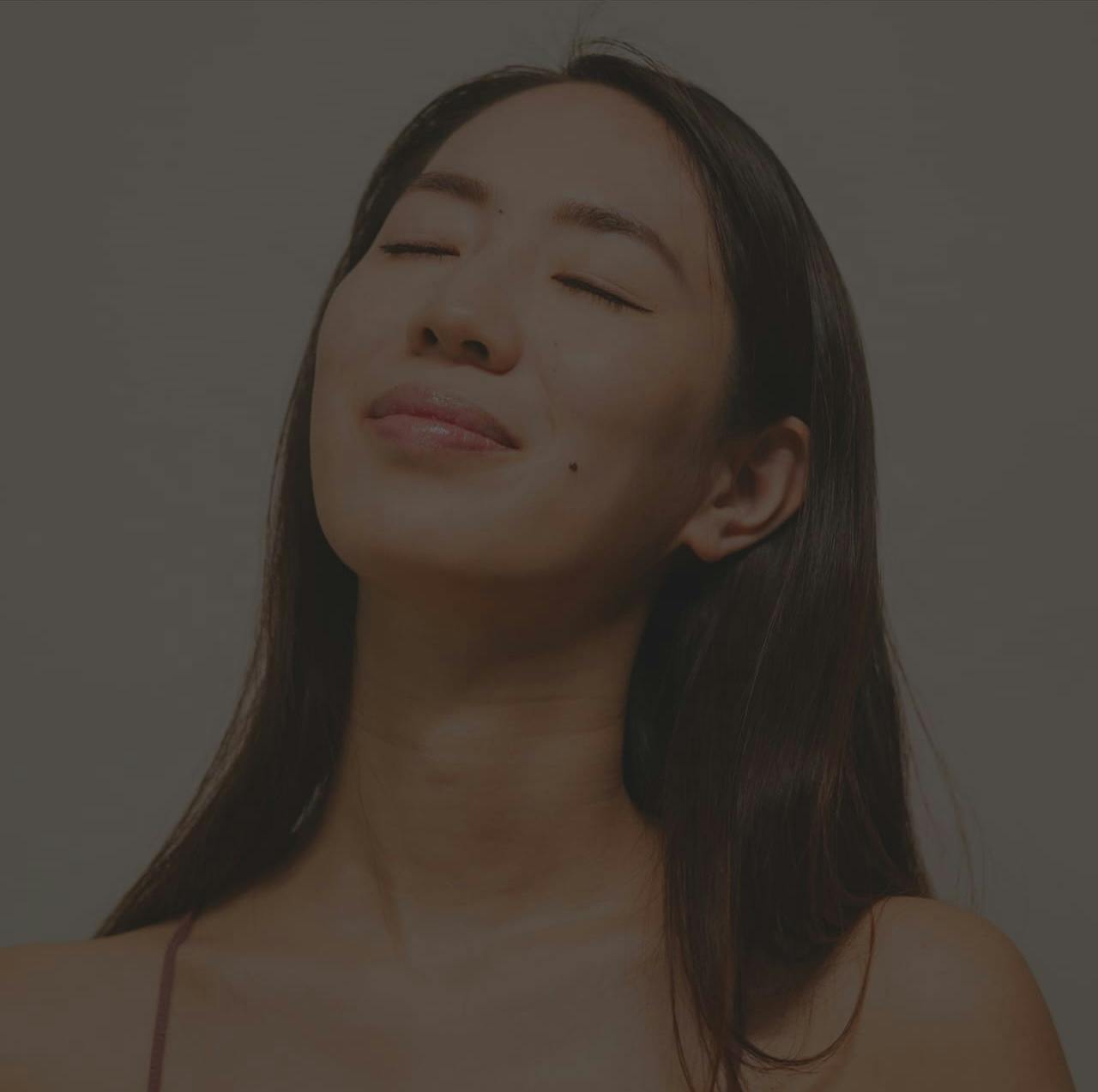 Woman smiling with eyes closed