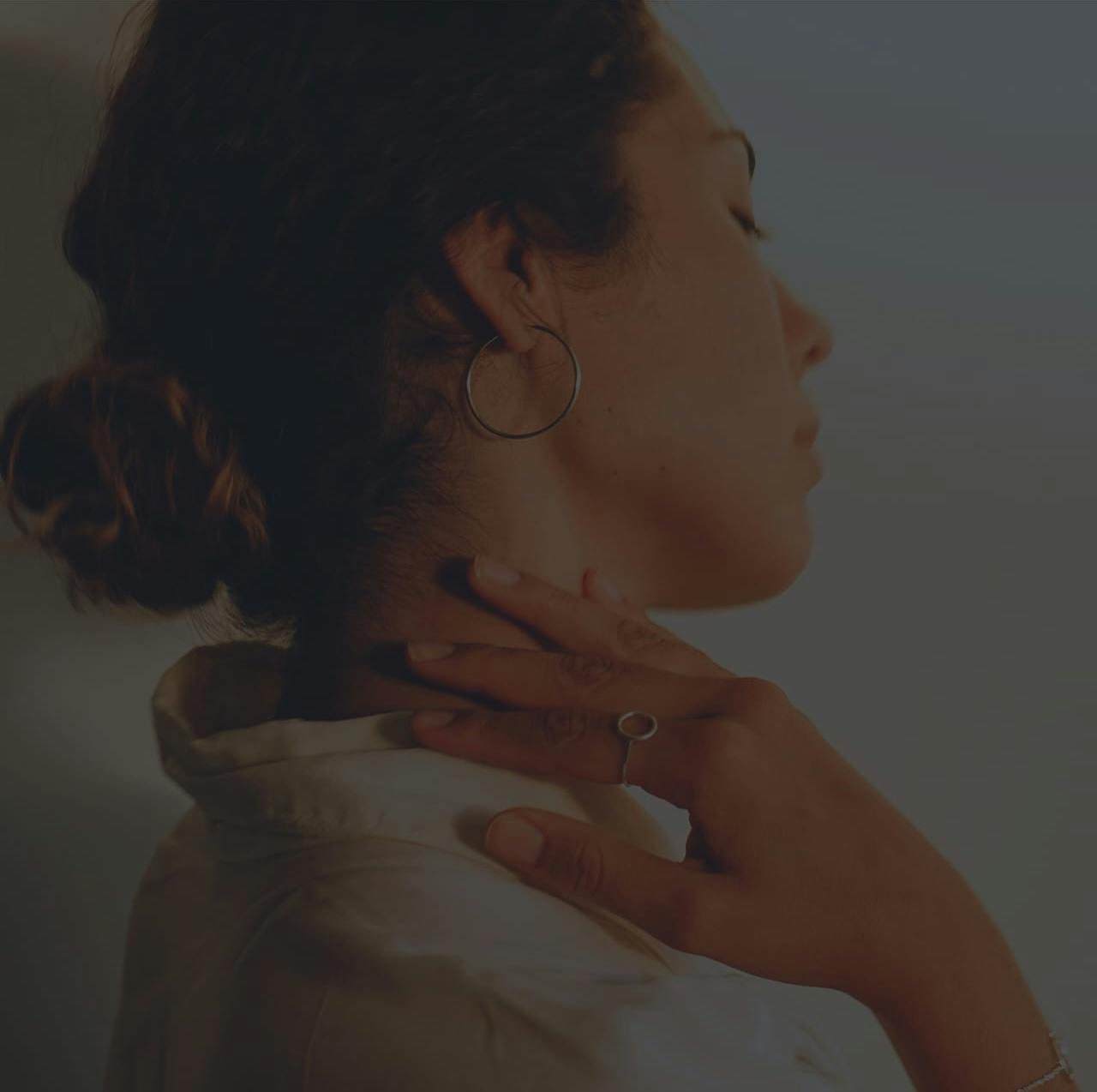 Woman holding her neck