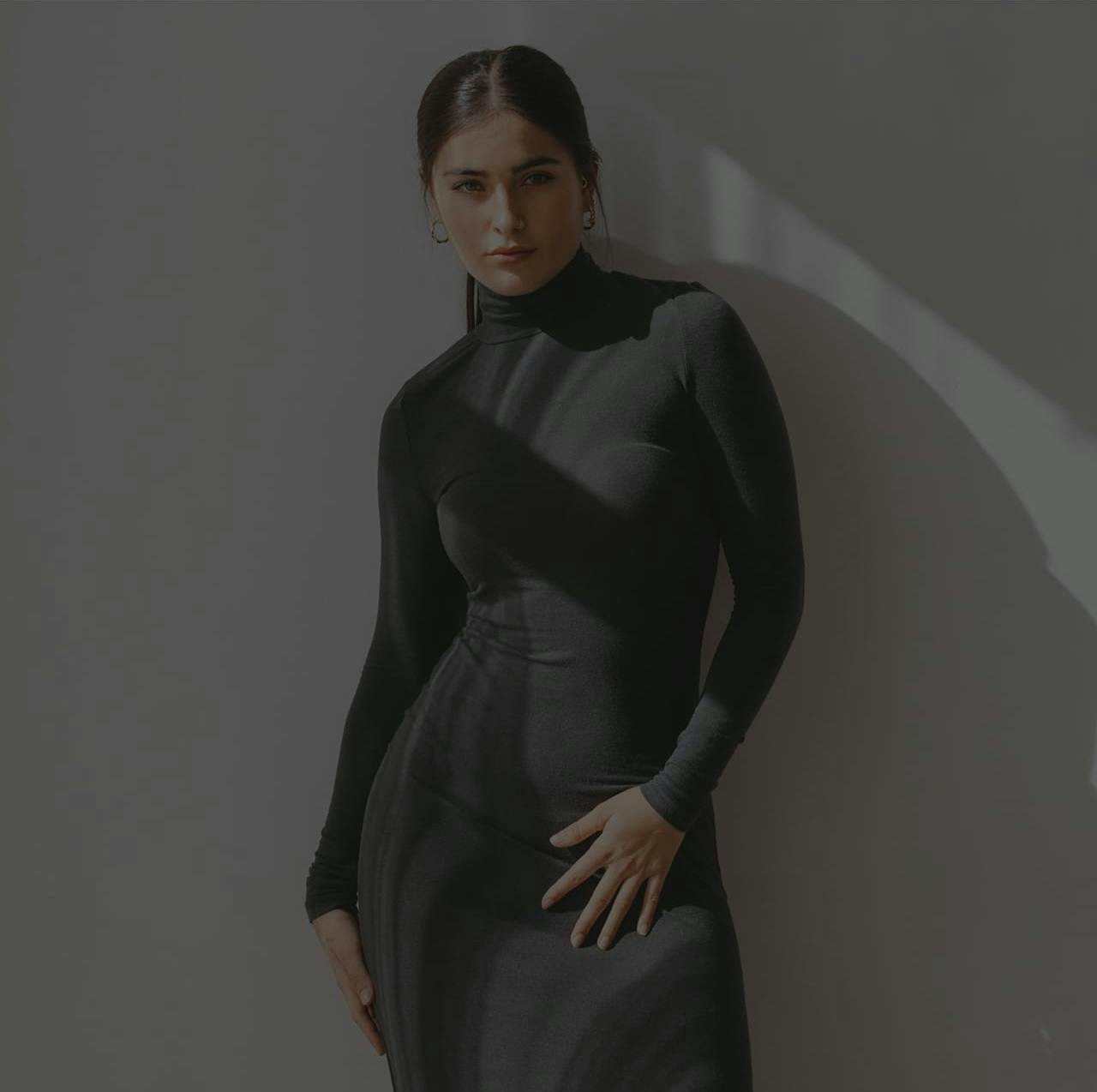 Woman leaning against a wall