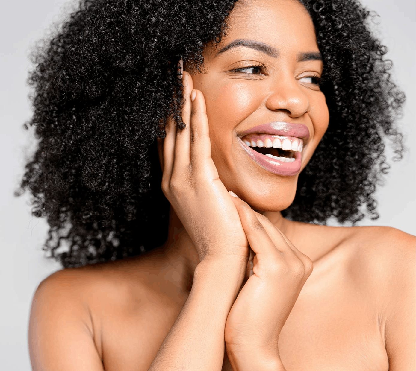 Woman smiling with hands on face