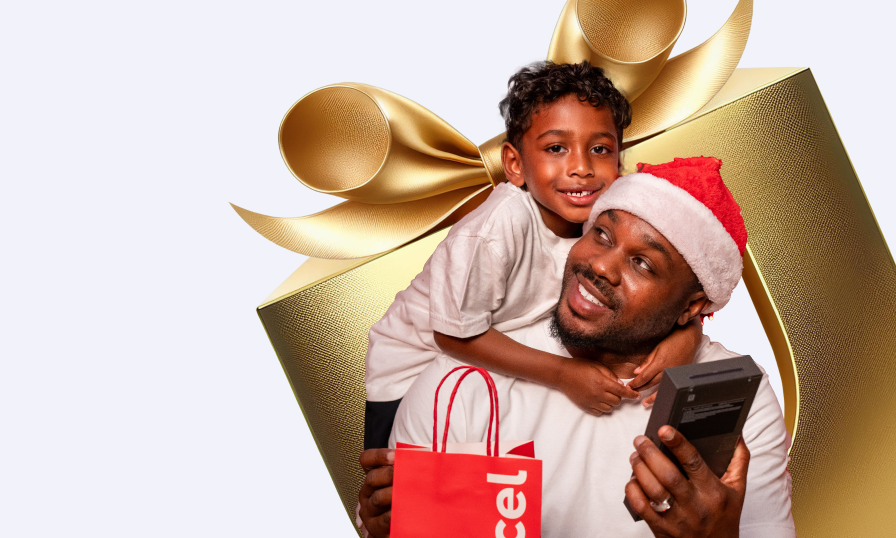 festive man and son with a smartphone
