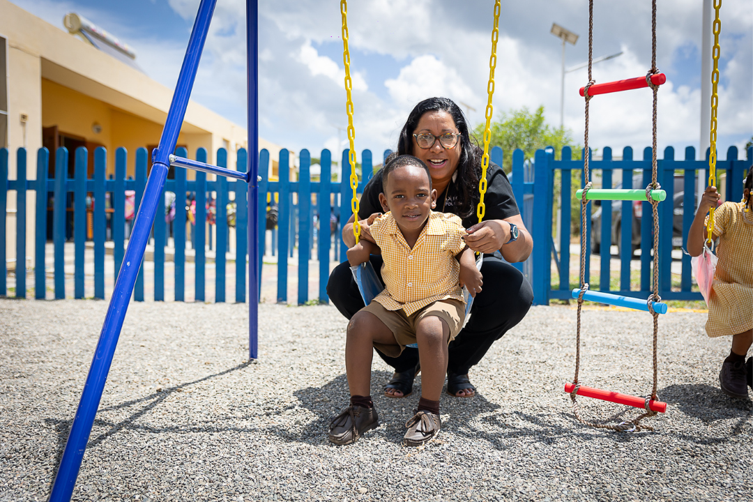 charmaine with boy on swing