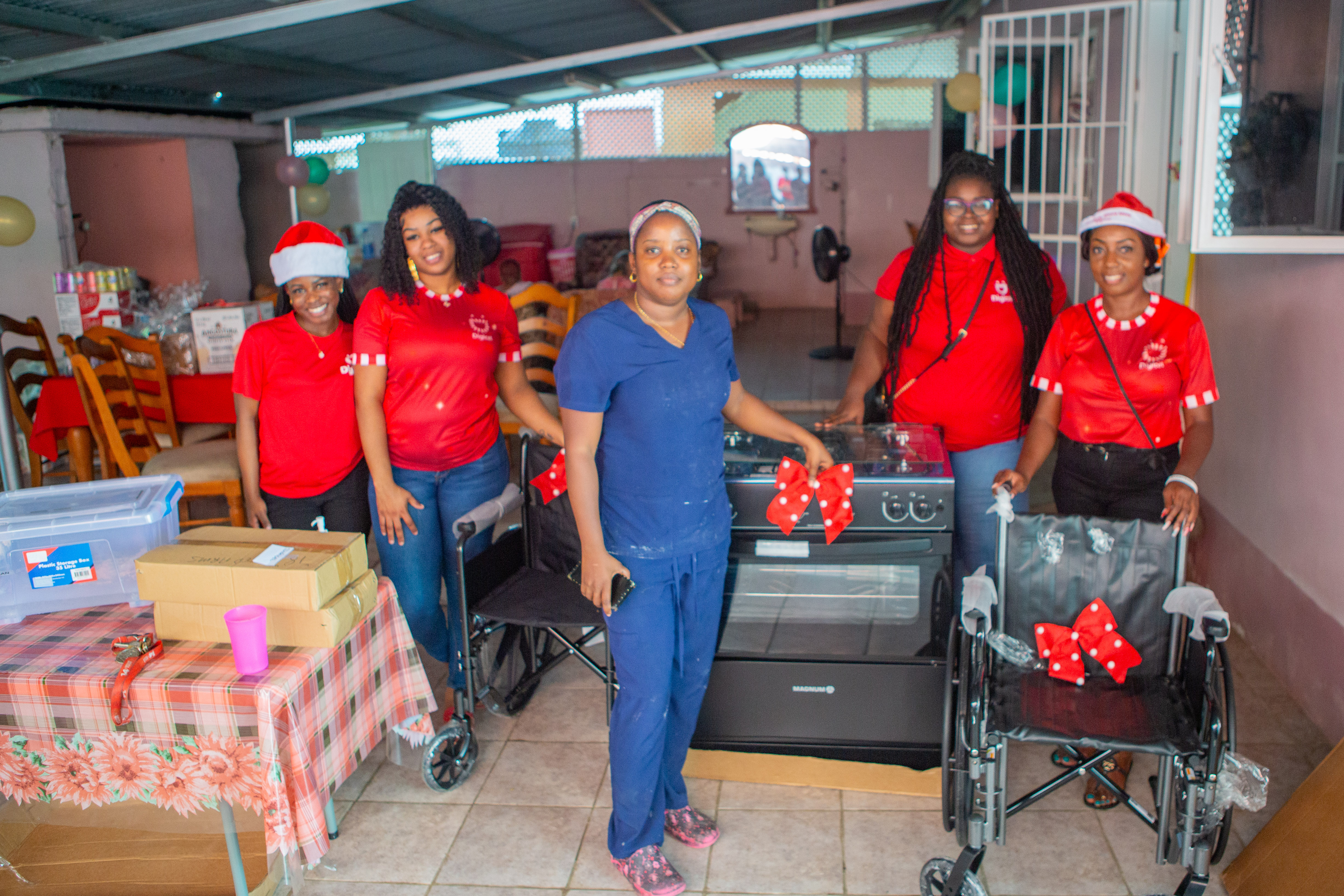 Digicel Staff stand in front of stove donation