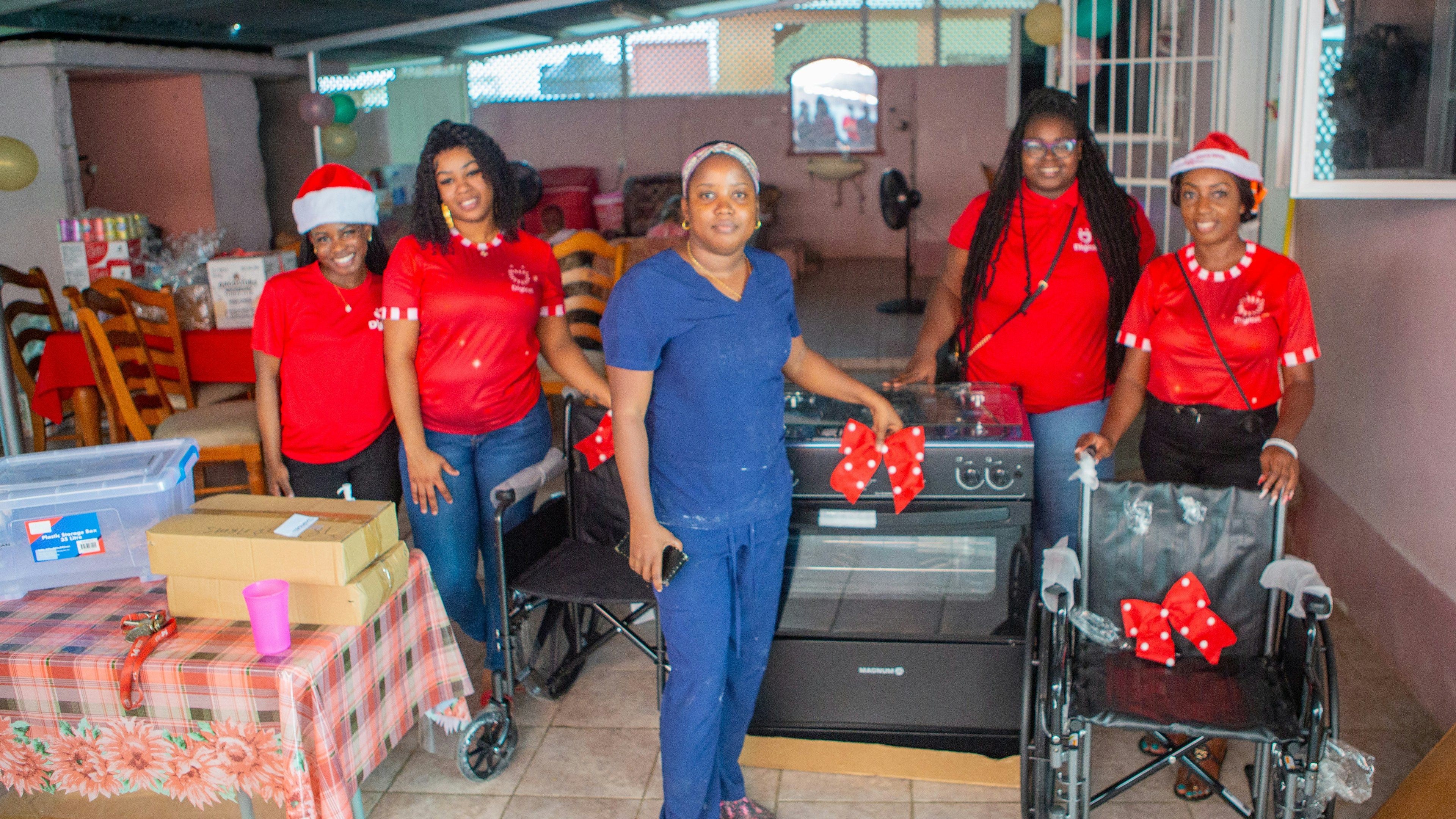 Digicel Staff stand in front of stove donation