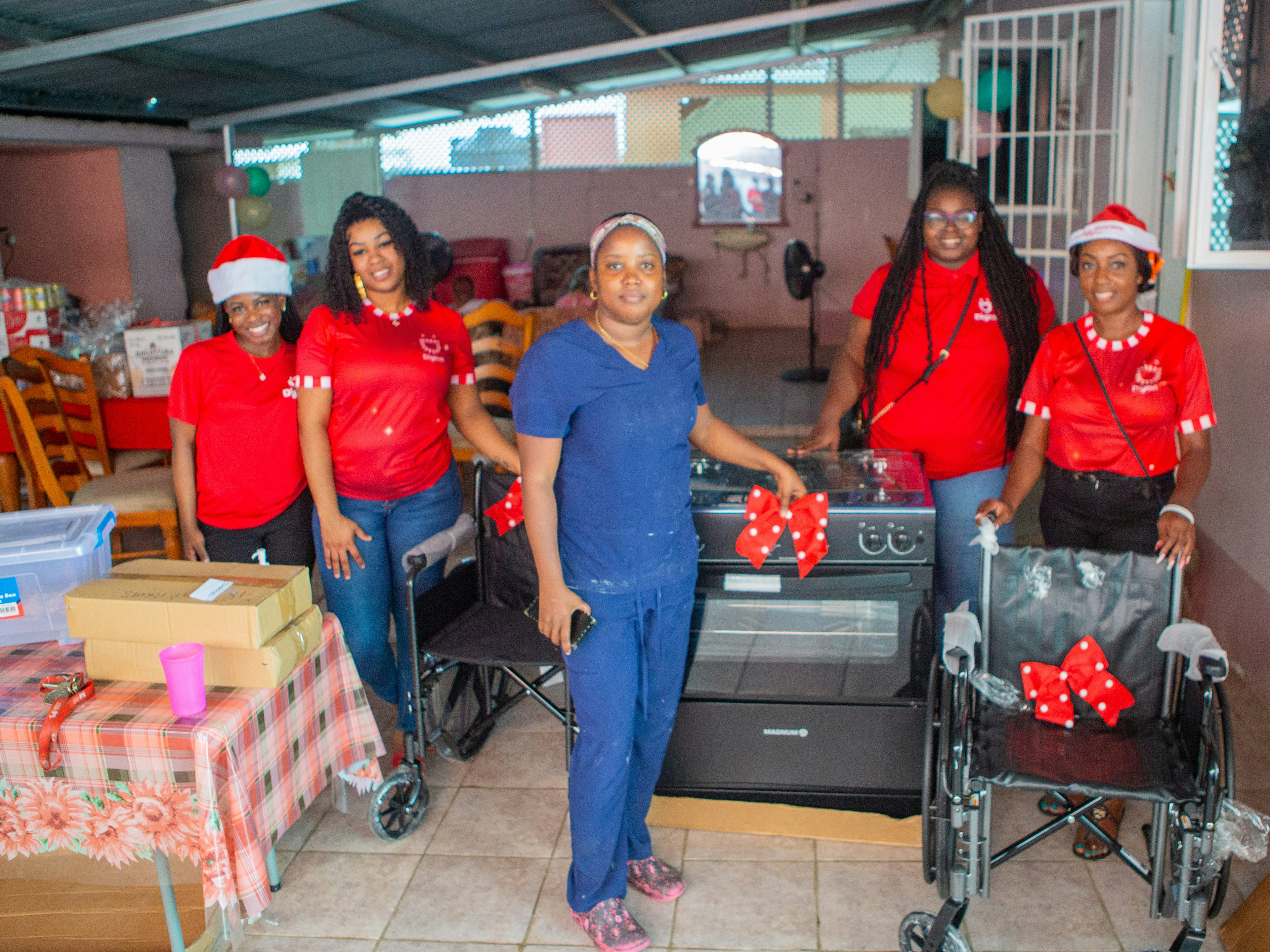 Digicel Staff stand in front of stove donation