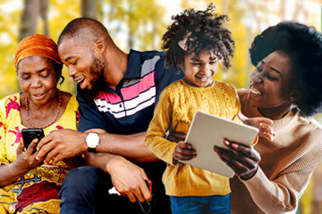 People smiling and looking at phone and tablet