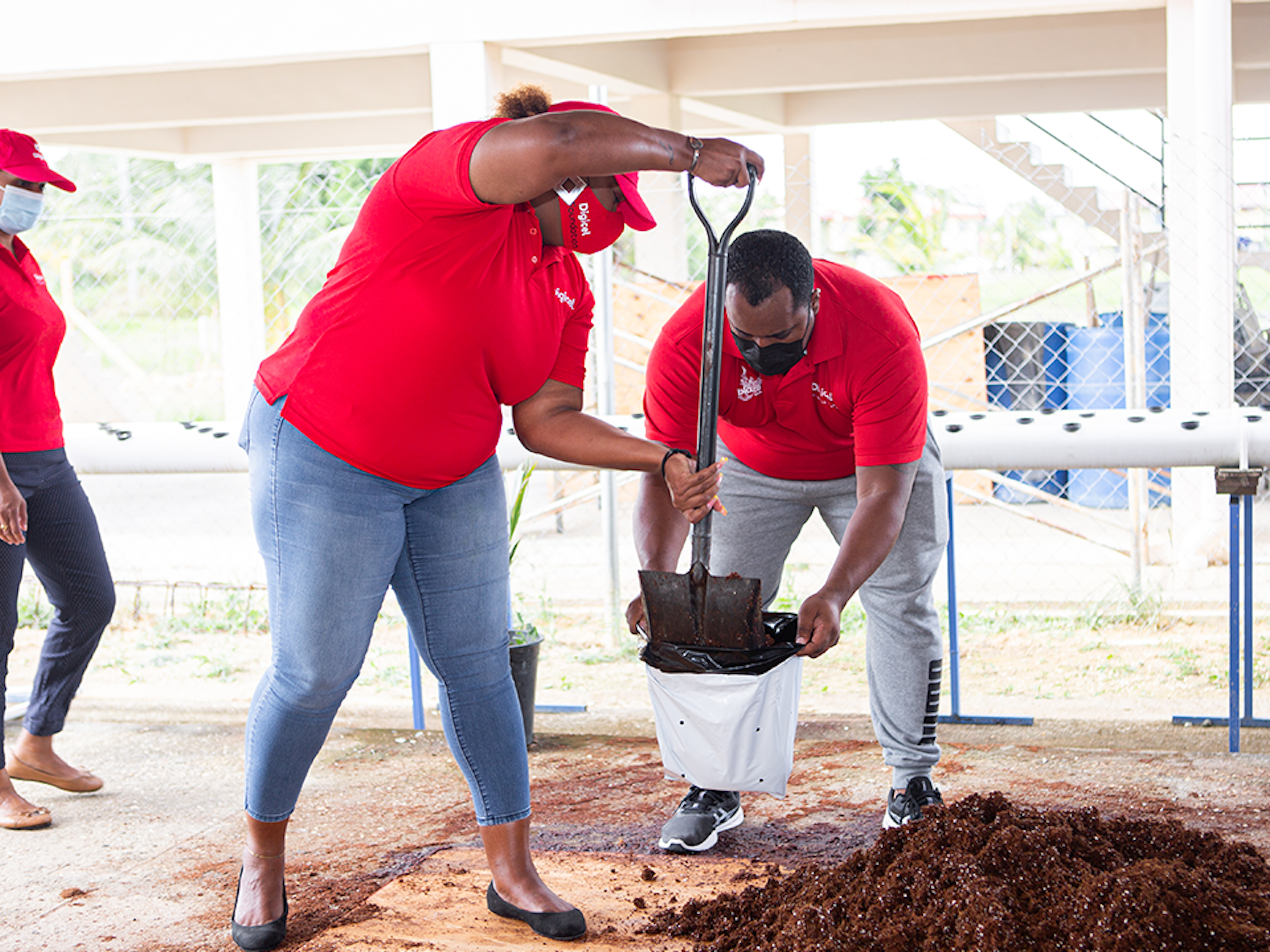 Digicel staff digging a garden