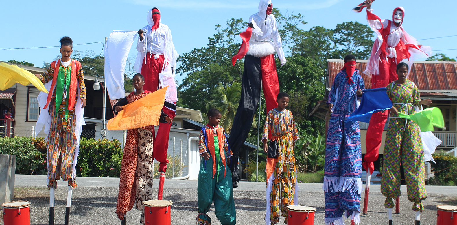 Drummers and Moko Jumbies in cultural wear