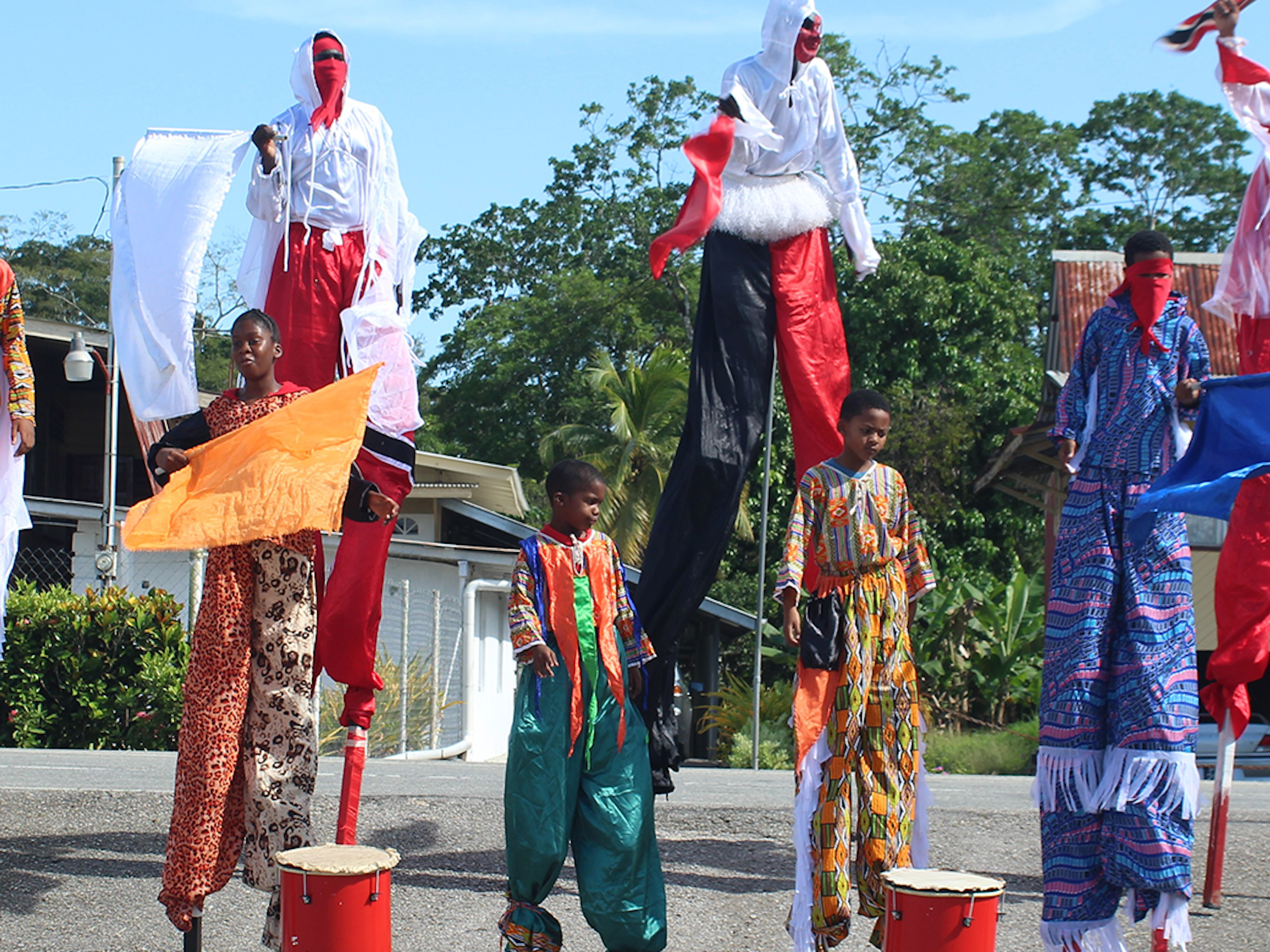 Drummers and Moko Jumbies in cultural wear