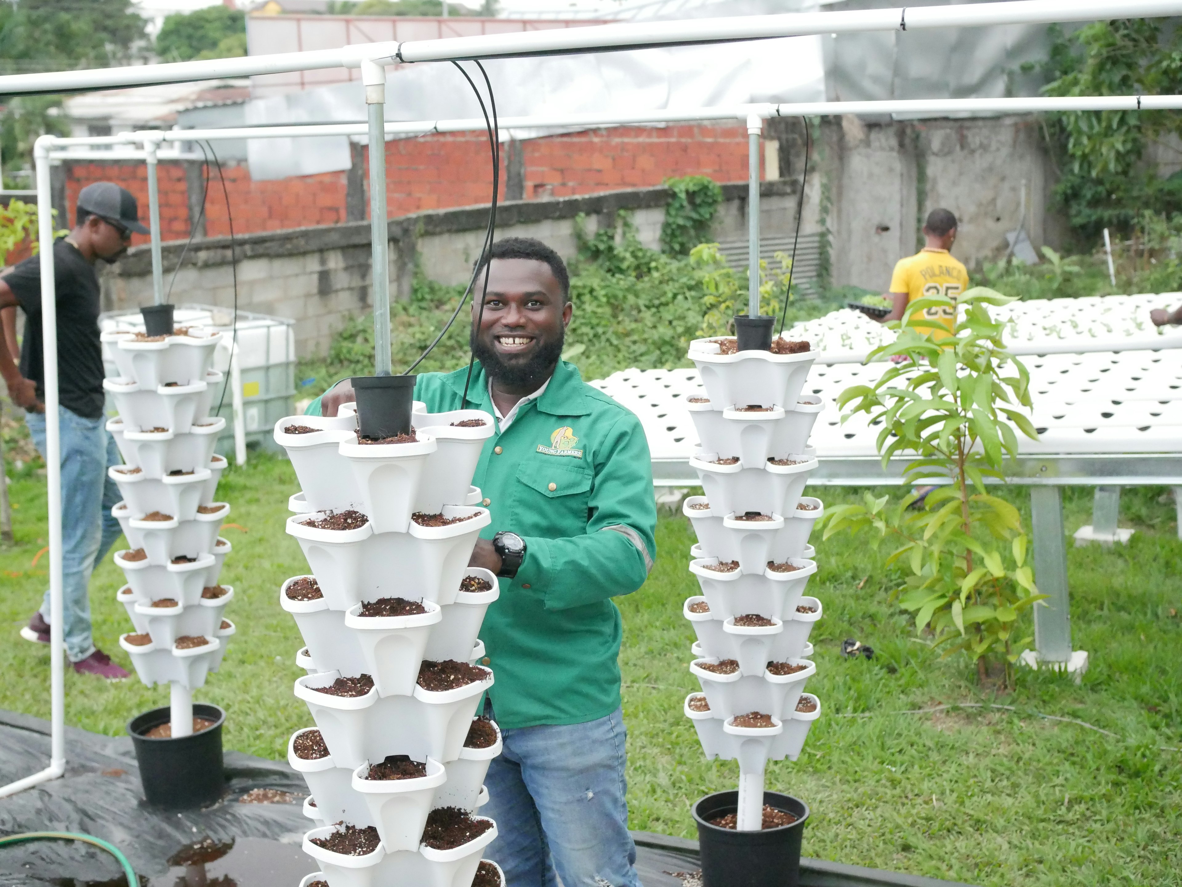 Partner setting up vertical hydroponics units