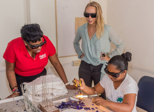 Three women making glass craft