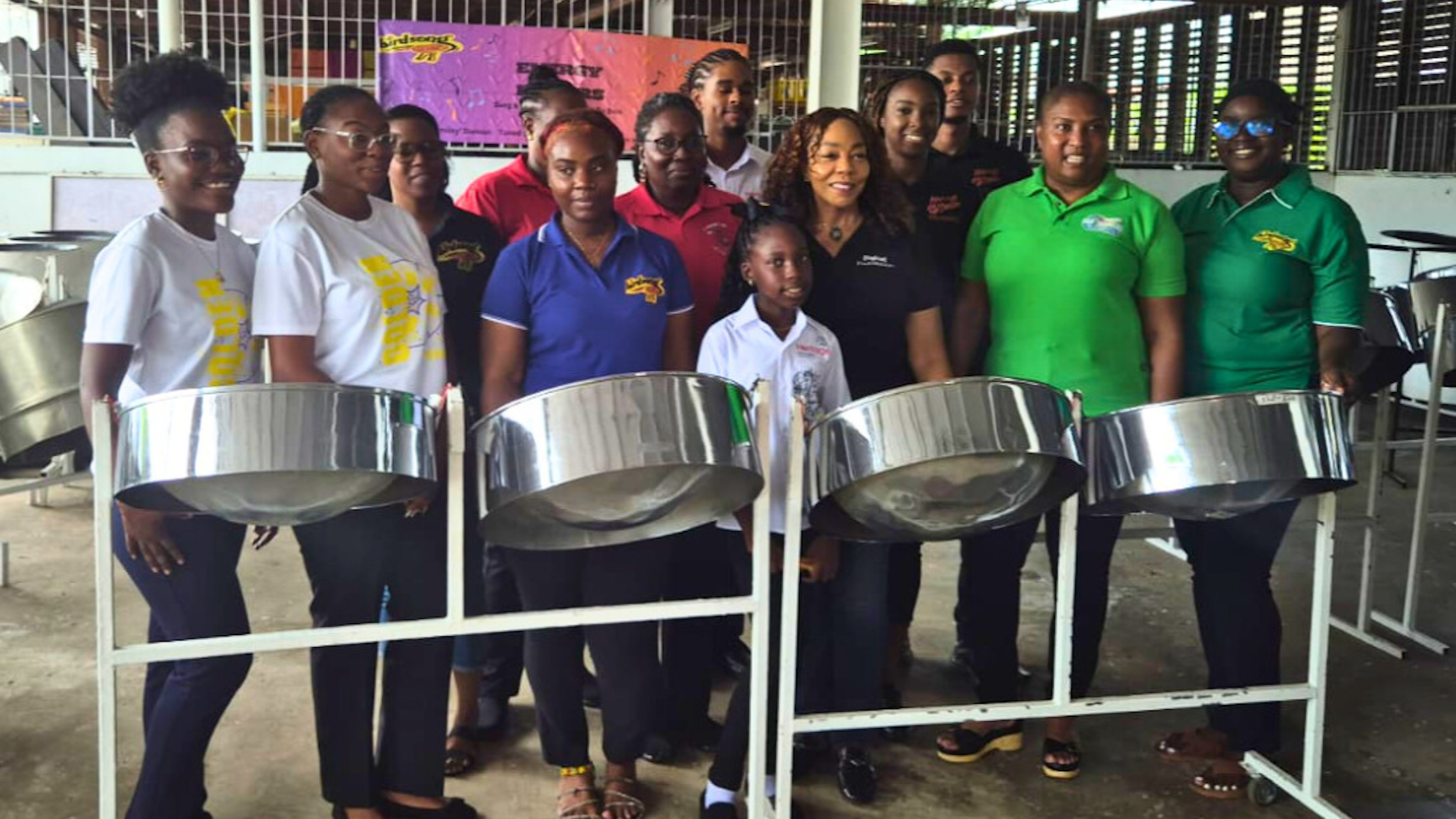 Pannists pose by steel pans with Digicel Foundation