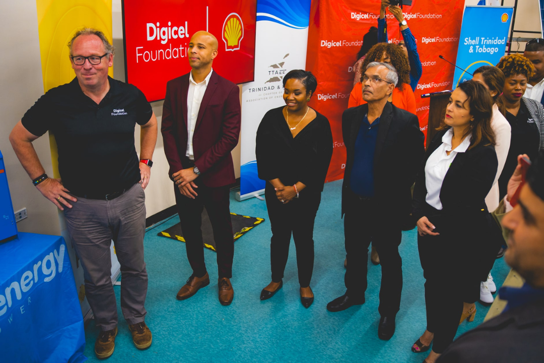 Stakeholders stand around new energy saving equipment